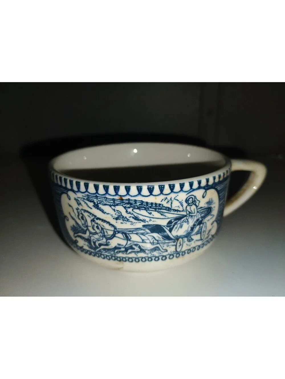 Vintage Blue and White Ceramic Cup with Horse and Carriage Design